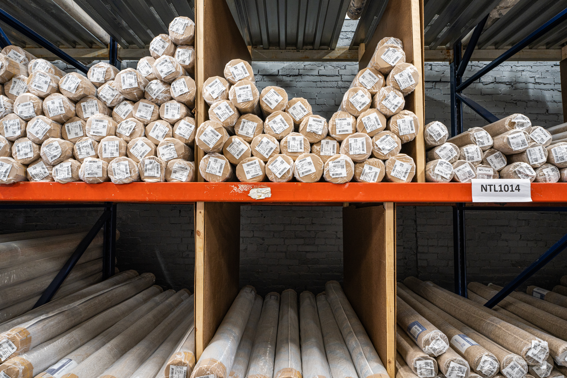 Organized rolls of products on racks at Lynx3PL, Inc.