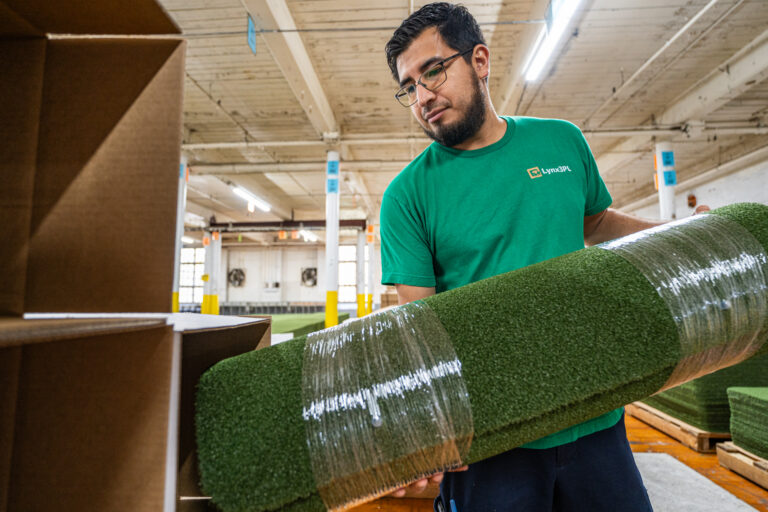 A man packing artificial turf for 3pl order fulfillment.